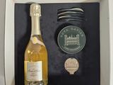 a bottle of wine and a coin in a box