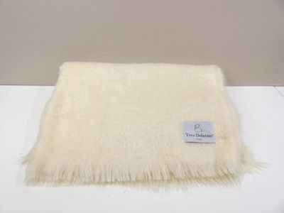 white blanket with a tag on it sitting on a white table