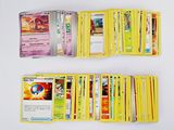 a lot of pokemon cards on a white table