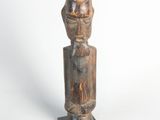 an old wooden statue of a man with a hat on it ' s head