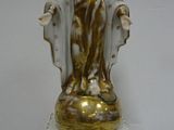 a figurine of a woman sitting on top of a table