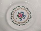 a close up of a plate with a rose on it