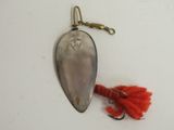 a silver spoon with a red hook attached to it