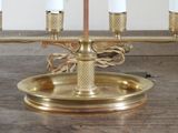a gold candle holder with five candles on it