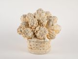 a white vase with a bunch of flowers in it