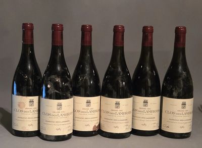 six bottles of wine are lined up in a row on a table