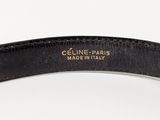 a close up of a black belt with a gold logo on it