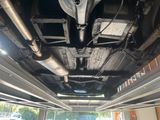 a car that is under a car in a garage