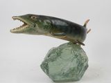 statue of a fish on a rock with its mouth open