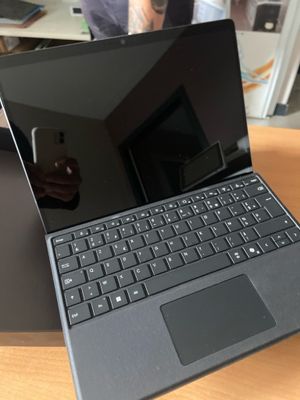 an open laptop computer sitting on top of a wooden desk