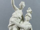 statue of a woman sitting on a man ' s lap