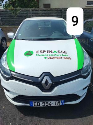 a white car with a green stripe parked in a parking lot