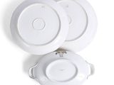 two plates and a bowl on a white surface