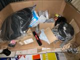 a cardboard box with many items in it on the floor