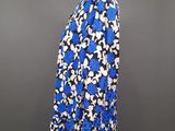 a woman ' s blue and white floral top on a mannequin stand