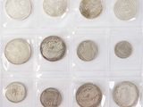 an assortment of silver and silver coins in a plastic case