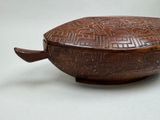 a wooden bowl with a lid that has a design on it