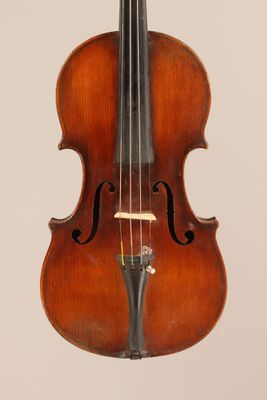 an old violin with a bow hanging from it ' s neck