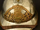 a silver helmet with a gold crown on it
