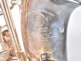 a close up of a silver saxophone with a silver bell