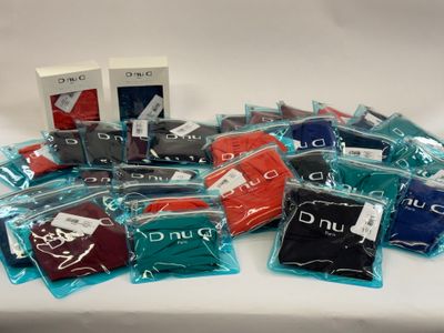 a pile of men ' s t - shirts on a table