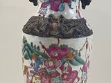 a large vase with a gold handle on a stand