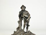 statue en bronze représentant un homme tenant un chien, sur fond blanc