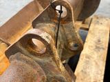 a close up of a piece of metal on a wooden table