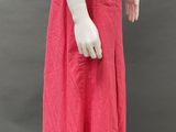 an image of a mannequin wearing a pink skirt and a beige shirt