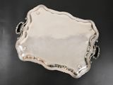 a silver tray on a black table with a chain around it