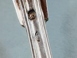a close up of a silver spoon on a table