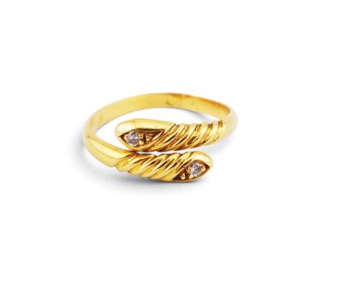 a close up of a gold ring on a white background