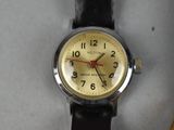 a close up of a watch on a white surface