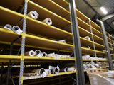many rolls of paper on the shelves in the warehouse