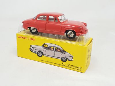 a red toy car sitting on top of a yellow box