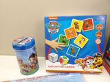 a box of paw patrol cards next to a can of soda
