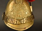 a gold helmet with a red rose on top of it