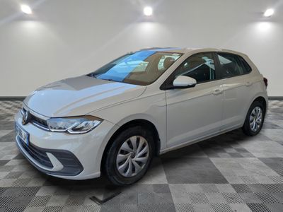 a white volkswagen golf parked in a room with a checkered floor