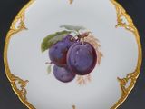 an image of a plate with a painting of plums on it