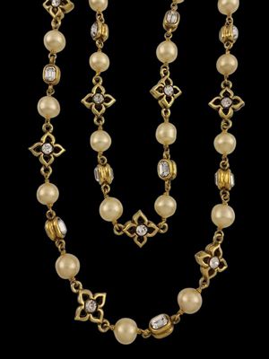 a gold and pearl necklace and bracelet set