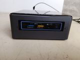 a small black device on a table with a charger