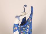 a figurine of a woman in a blue dress