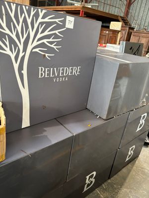 boxes stacked on top of each other with a bottle of wine on top of them
