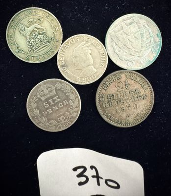 six pièces de monnaie britanniques différentes sont posées sur une surface noire, accompagnées d'une étiquette de prix