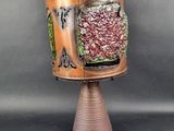 a lamp that is on top of a wooden stand