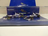 a blue display case with three racing cars on it