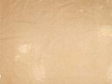 an old piece of paper on a white background with a torn piece of paper