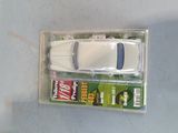 a toy car in a plastic box on a table