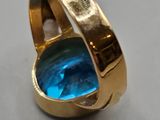 an image of a ring with a blue stone inside of it