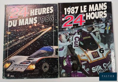 two books on a table with a picture of a race car in the background